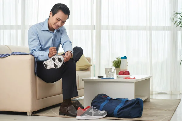 Businessman changing clothes for sport training