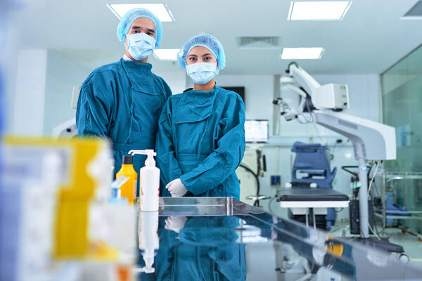 Surgeon and nurse in masks