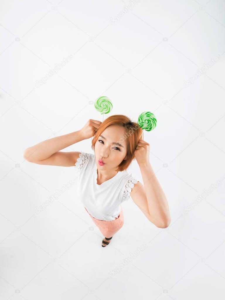 Funny girl with green lollipops 