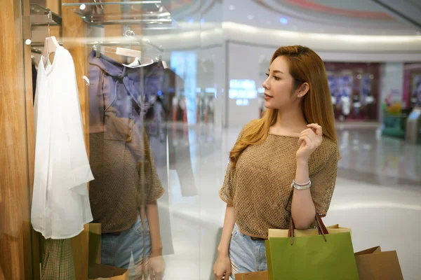 O femeie se uită la haine în magazin — Fotografie, imagine de stoc