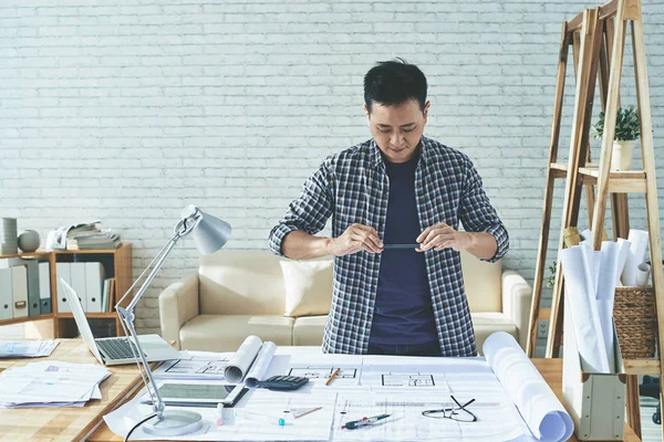 Architect photographing blueprint — Stock Photo, Image