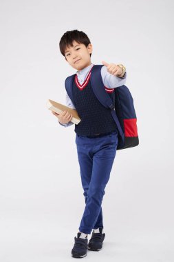 başparmak kadar gösteren bir okul çocuğu