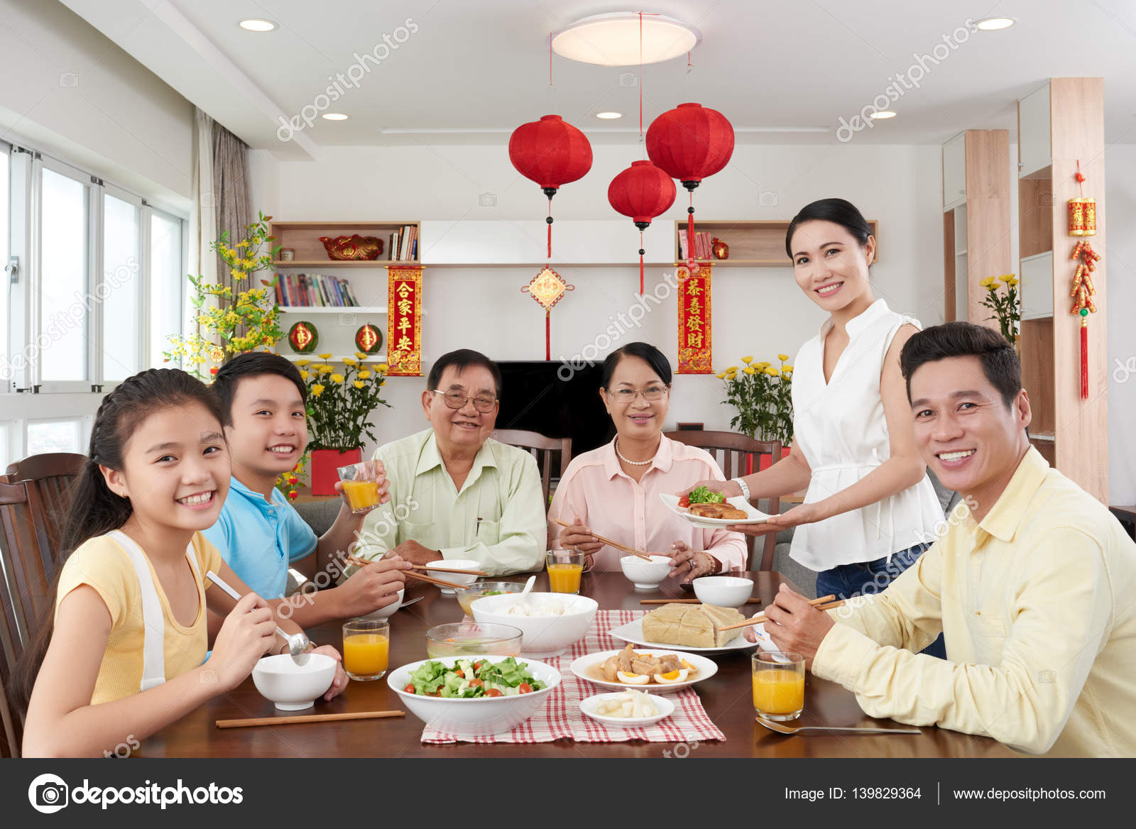 Happy family having dinner — Stock Photo © DragonImages #139829364