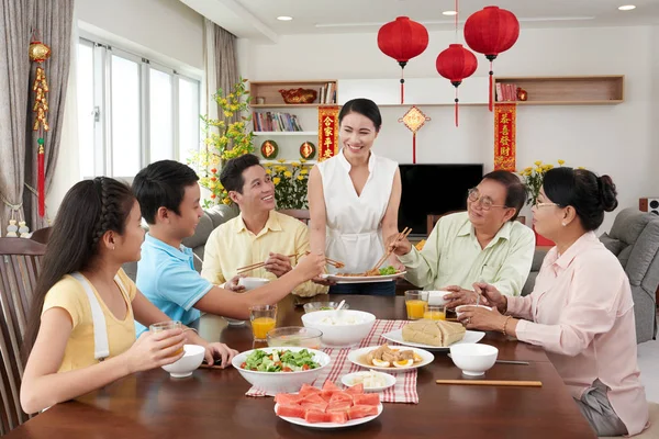 Family members taking spring rolls — Stock Photo, Image