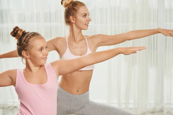 Girl and her mother enjoying yoga practicing — Stock Photo, Image