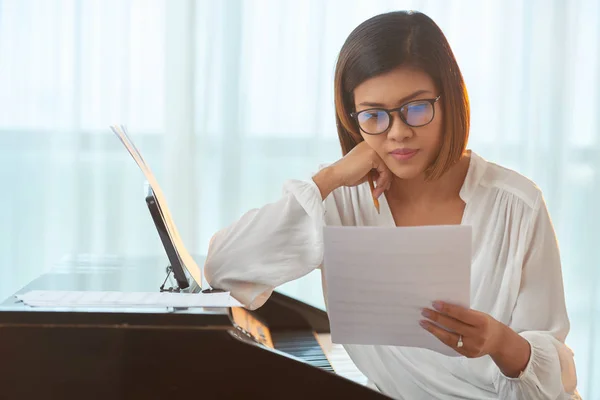 composer looking at music notes