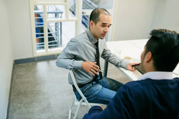 Mann sitzt am Tisch und schaut — Stockfoto