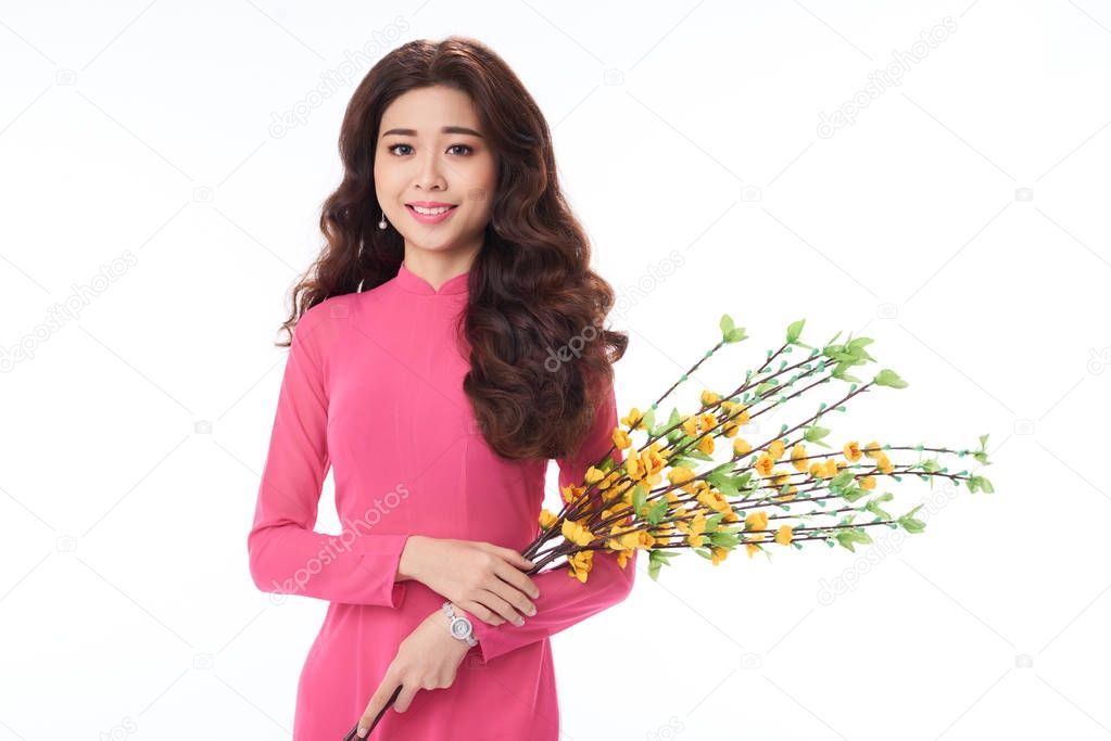 asian woman with ochna tree branches in hands, isolated on white background