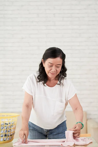 Portrait Senior Housewife Folding Fresh Dry Clothes — Stock Photo, Image