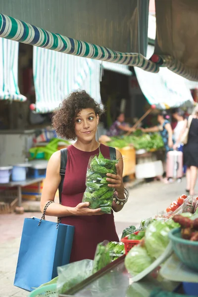 Funny woman with pack of bitter gourd