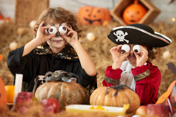 Children making funny faces with plastic eyeballs