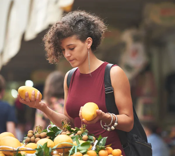 Vegetarian woman shopping for fresh fruits at market
