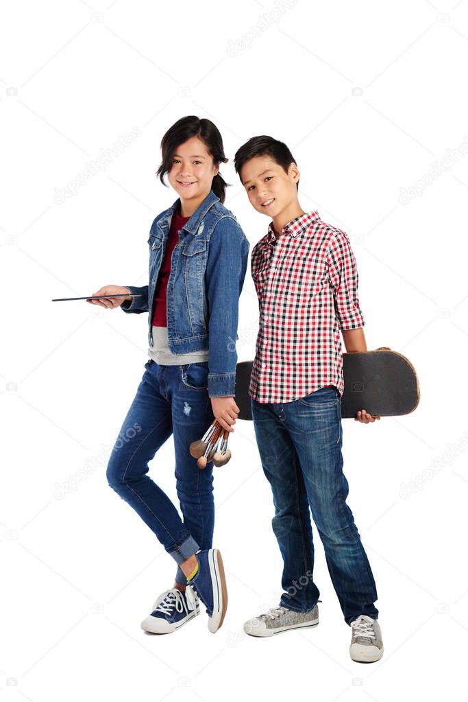 Twins with different hobbies: girl likes make-up but her brother likes skateboarding