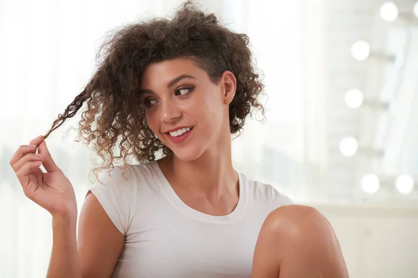 Smiling Young Woman Looking Her Curly Hair — Stock Photo, Image
