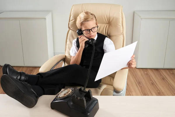 Confident Little Businessman Reading Document Calling Telephone — Stock Photo, Image