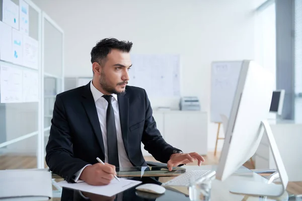 Businessman Suit Writing Plan Paper Looking Computer Monitor Workplace Table — Stock Photo, Image