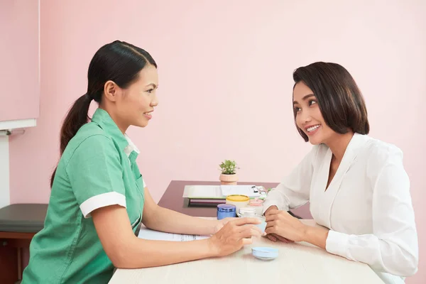 Kosmetikerin Und Kundin Diskutieren Neue Produkte Für Die Hautpflege — Stockfoto