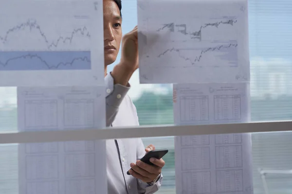 Businessman Taking Notes Financial Charts Hanging Wall — Stock Photo, Image