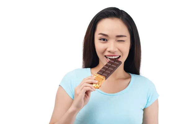 Asian Woman Biting Chocolate Bar — Stock Photo, Image
