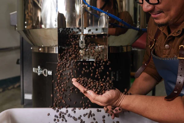 Man Catching Coffee Beans Falling Out Roaster Machine — Stock Photo, Image