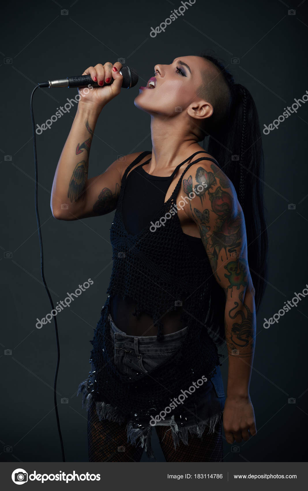 Female Rock Star Singing Song Isolated Dark Background Stock Photo by  ©DragonImages 183114786