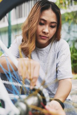 Vietnam kadın bisikletçi zinciri üzerinde bisiklet tamir