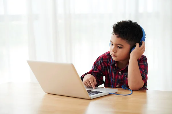 Pensive Mixed Race Boy Headphones Watching Music Clips Laptop — Stock Photo, Image