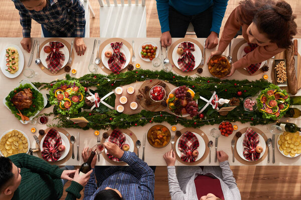 Group of people having dinner on Christmas night, view from above