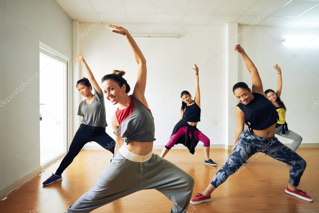 sportive women practicing choreography in dancing studio