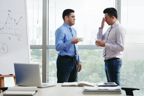 Coworkers having small talk during the coffee break