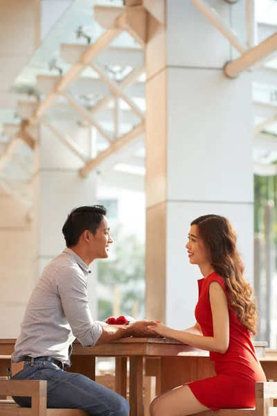 手を繋いでいると カフェのテーブルで話しているアジアの若いカップル — ストック写真
