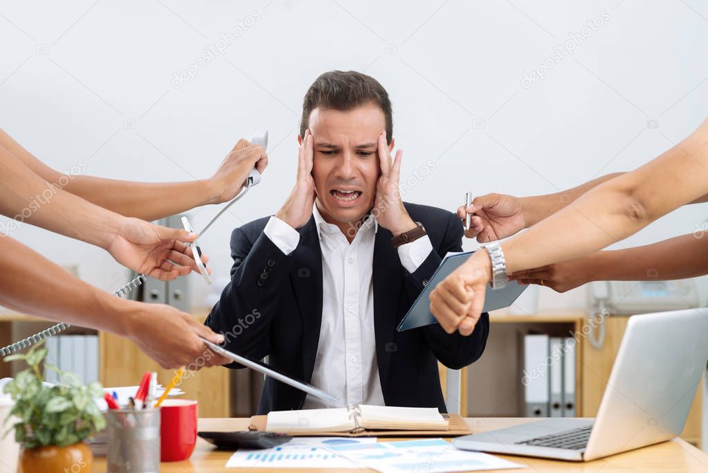 Businessman having panic attack because of many tasks given to him