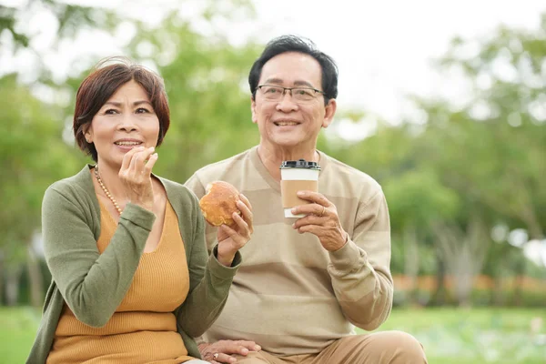 Gelukkige Senior Aziatische Paar Eten Van Broodjes Drinken Take Out — Stockfoto