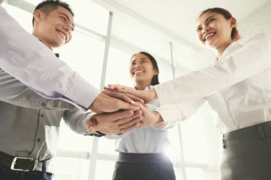 Neşeli Vietnamca iş takım destek ifade etmek için yığın eller