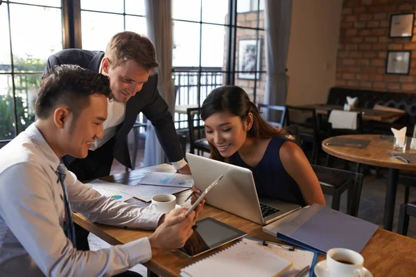 Cheerful Vietnamese Businessman Showing Document Tablet Computer His Colleagues — Stock Photo, Image