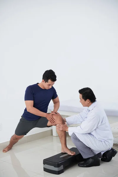 Young Man Doing Exercise Doctor Checking His Knee — Stock Photo, Image