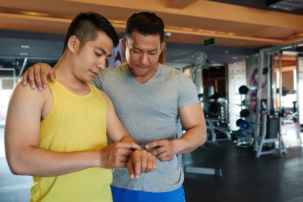 Visitante Ginásio Mostrando Informações Sobre Rastreador Fitness Para Seu Instrutor — Fotografia de Stock