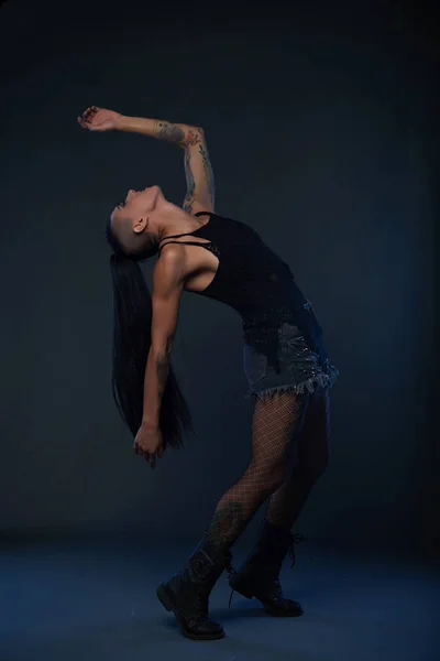 網タイツや暗闇の中で踊るデニム ショート パンツに反乱の女の子 — ストック写真