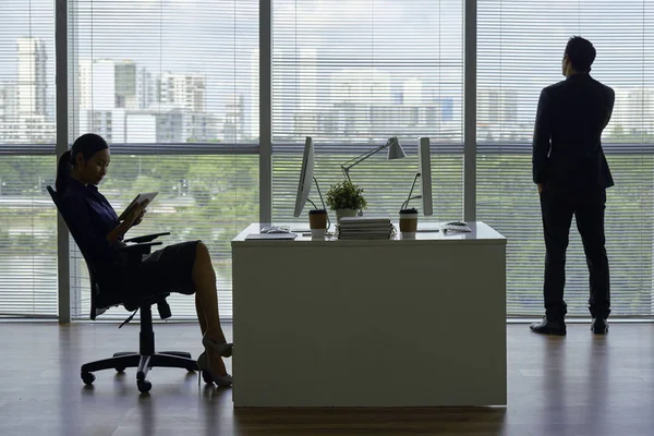 Businesswoman Reading Information Tablet Computer Her Coworker Talking Phone Looking — 스톡 사진