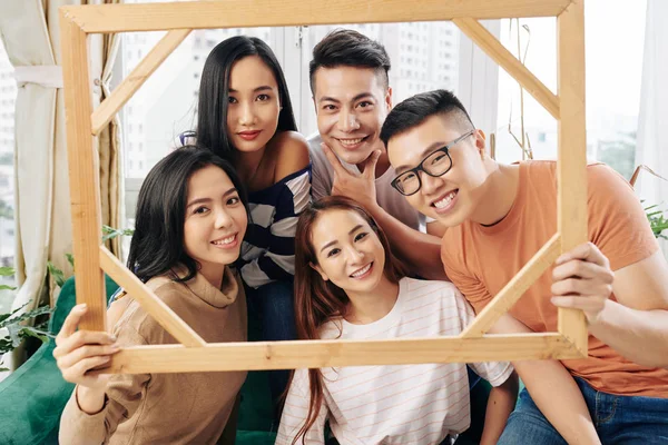 Cheerful Beautiful Young Vietnamese People Holding Big Wooden Frame Looking — Stock Photo, Image