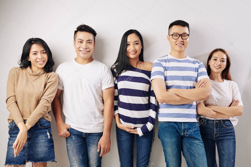 Portrait of young confident happy Vietnamese university students looking at camera