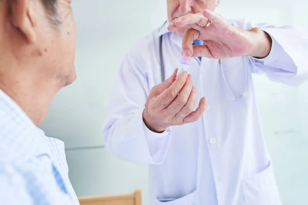 Close Image Doctor Showing Small Bottle Eye Drops Senior Patient — Stock Photo, Image