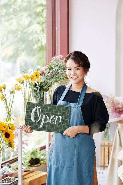 Lovely Smiling Vietnamese Florist Blue Apron Holding Open Sign Looking — Stock Photo, Image