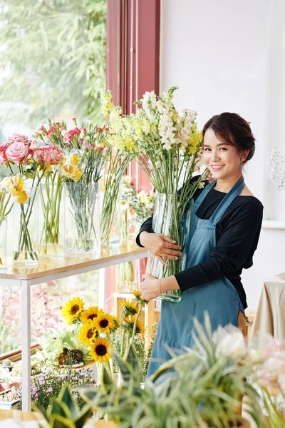 Cheerful Young Asian Florist Standing Flowers Transparent Glass Vase — Stock Photo, Image