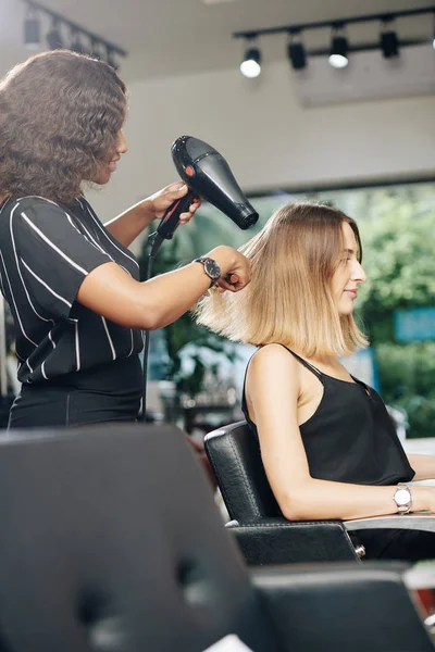 Stylist Using Professional Dryer Blowdrying Hair Young Pretty Woman Her — Stock Photo, Image