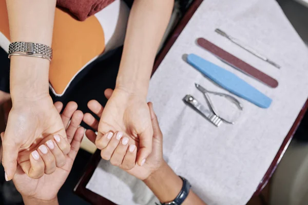 Manicurist Examining Hands Female Client Starting Manicure Process View — 스톡 사진