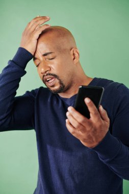 Unutkan adam, önemli bir telefon görüşmesi yapmayı unuttuğunu fark edince, yüz hareketi yapıyor.