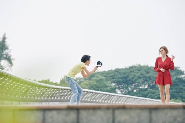 Gülümseyen güzel seyahat blogcusu asistanının yardımıyla yeni video çekiyor