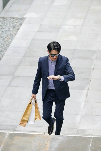 Young Man Paper Bags Walking Stairs Checking Time His Wristwatch — Stock Photo, Image