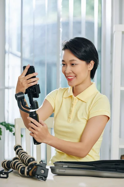 Smiling Pretty Vietnamese Woman Holding Monopod Smartphone Checking Settings Shooting — 스톡 사진